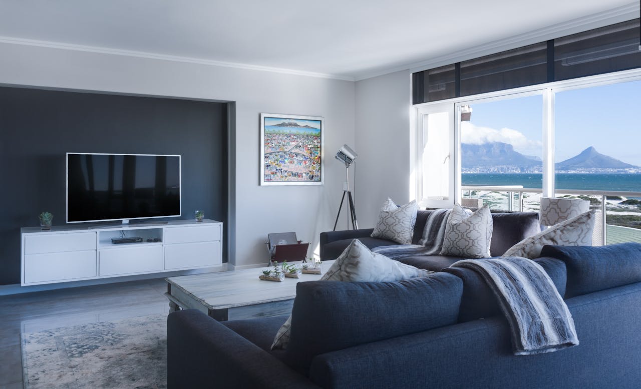 Services-01 Stylish living room with a view of Table Mountain, blending modern design with natural beauty.
