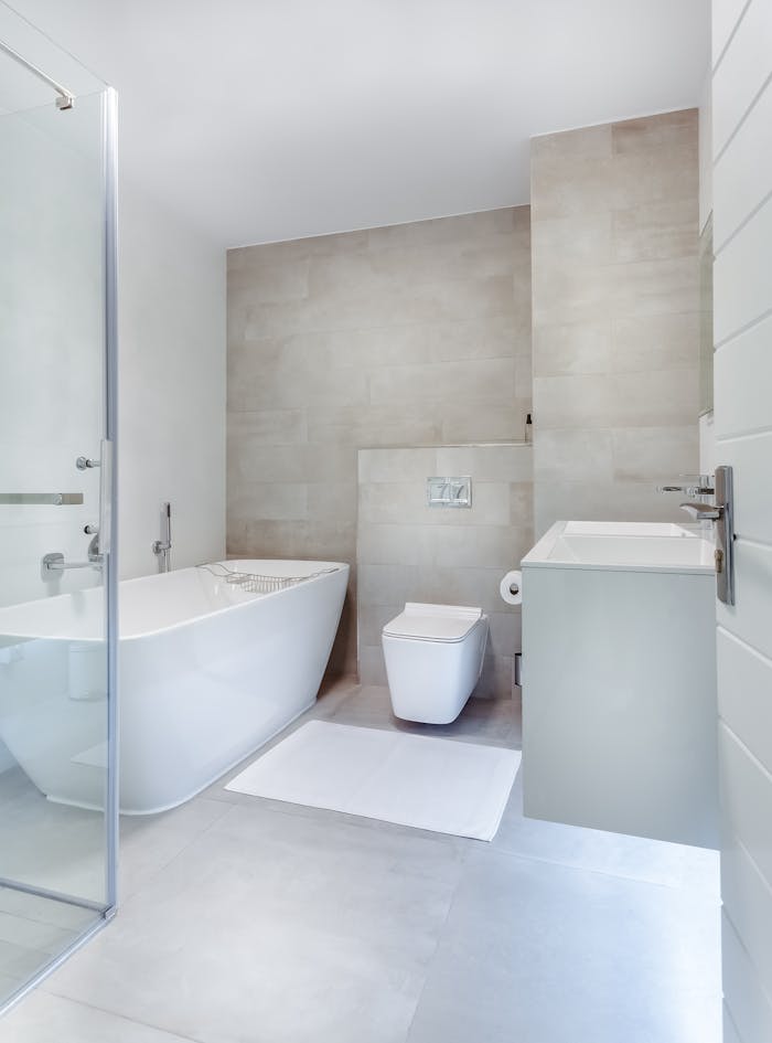 creative-01 Elegant minimalistic bathroom featuring bathtub and sleek fixtures.