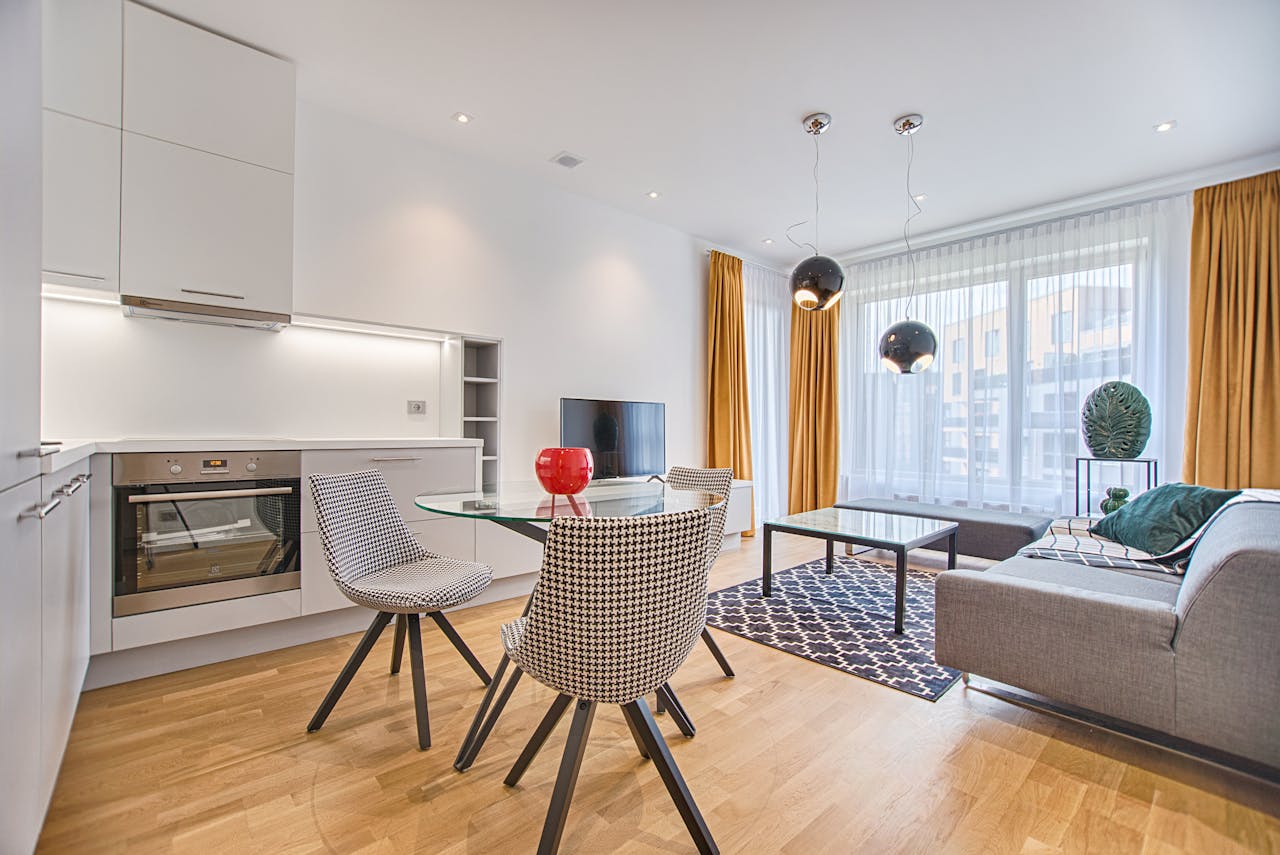 digital Elegant Scandinavian-style living room and kitchen featuring modern furniture and decor.