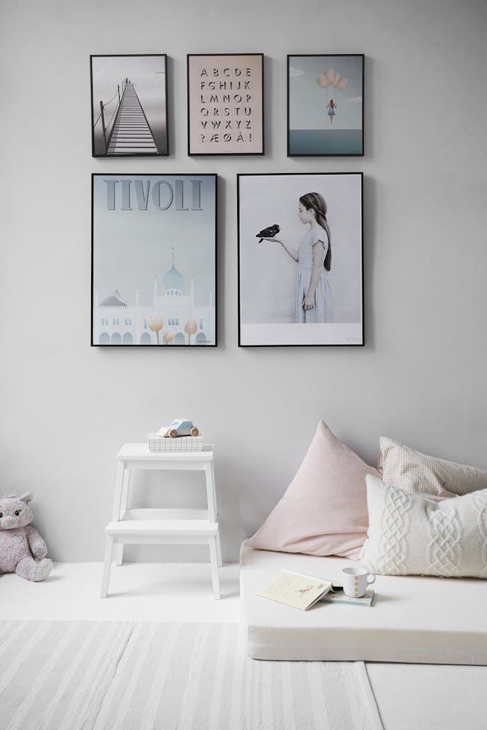 why-choose-us Minimalist Scandinavian bedroom with wall art and cozy decor elements.